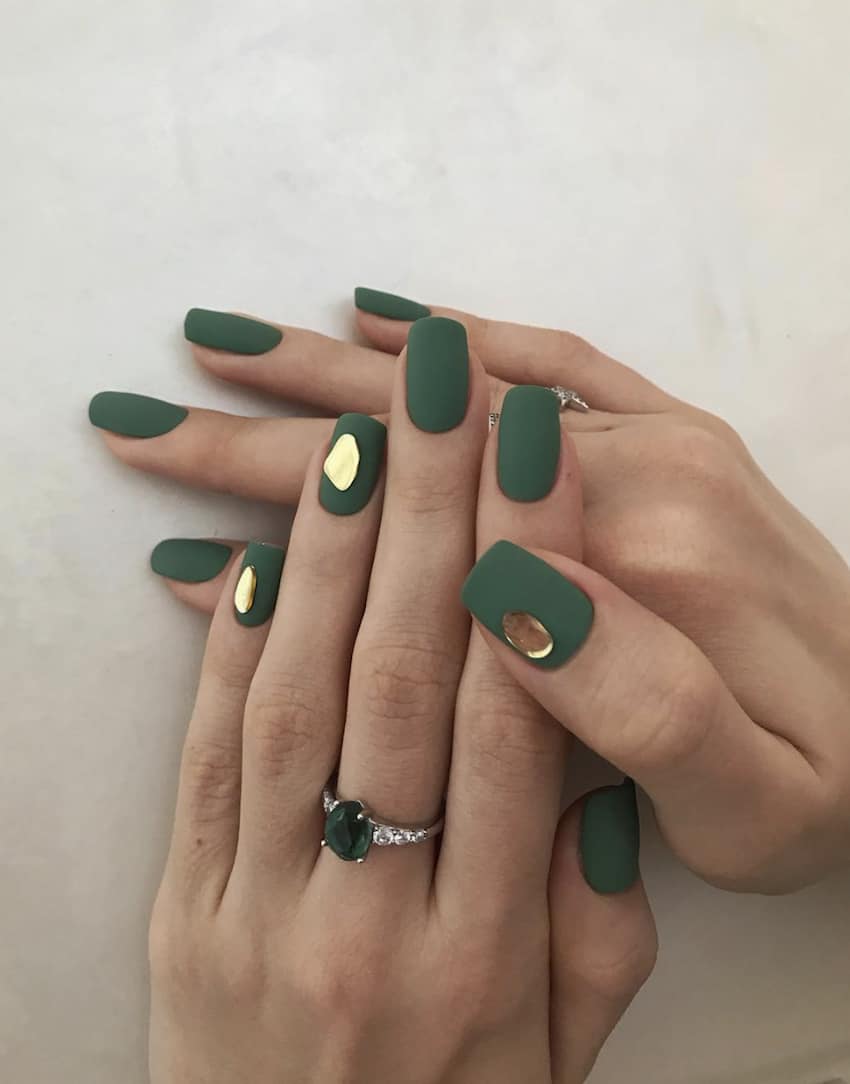 Square, matte emerald green nails with gold gems.
