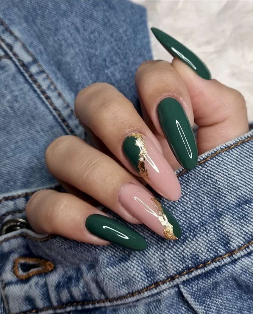 Emerald green nails with gold leafing accent nails.