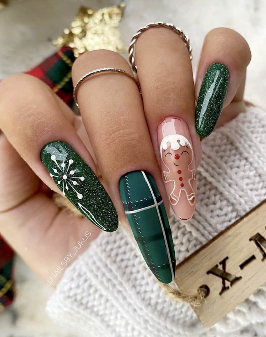 Emerald green Christmas theme nails with a gingerbread man accent nail.