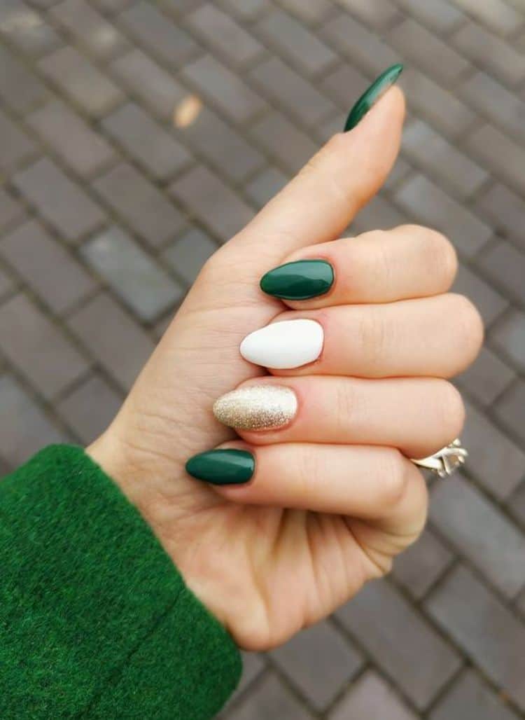 White, gold and emerald green nails.