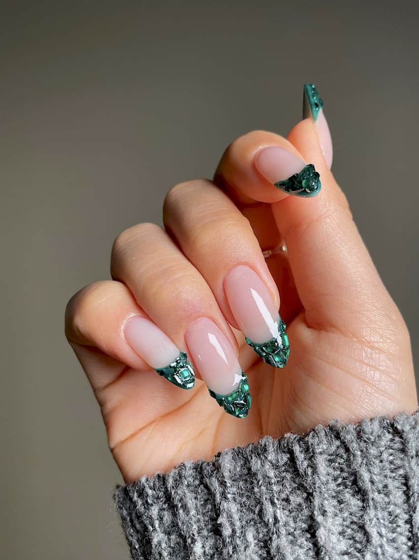 French manicure with emerald green gemstone tips.