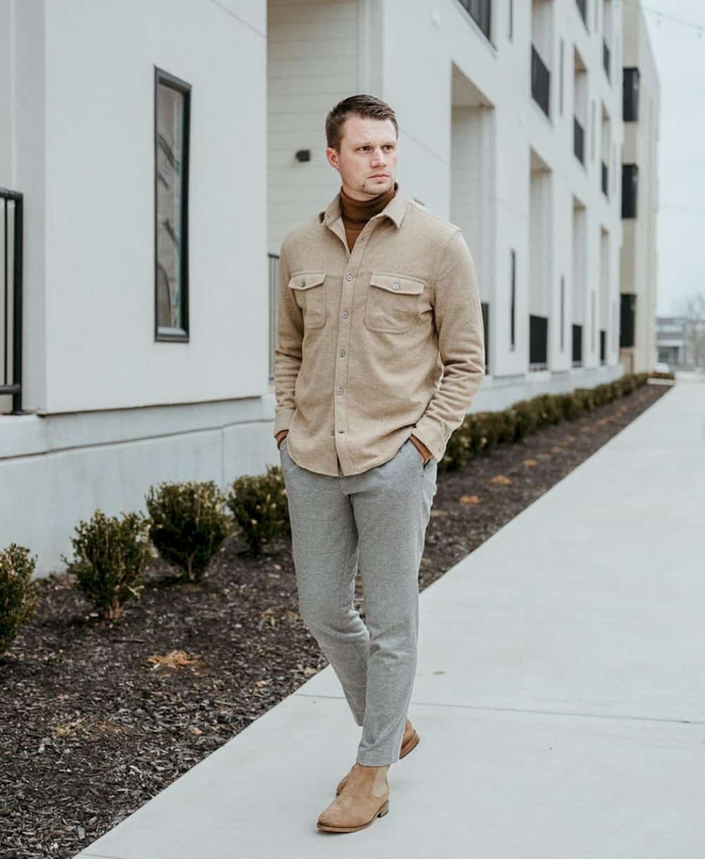 image of a man wearing a beige fleece shirt, grey pants, and brown boots