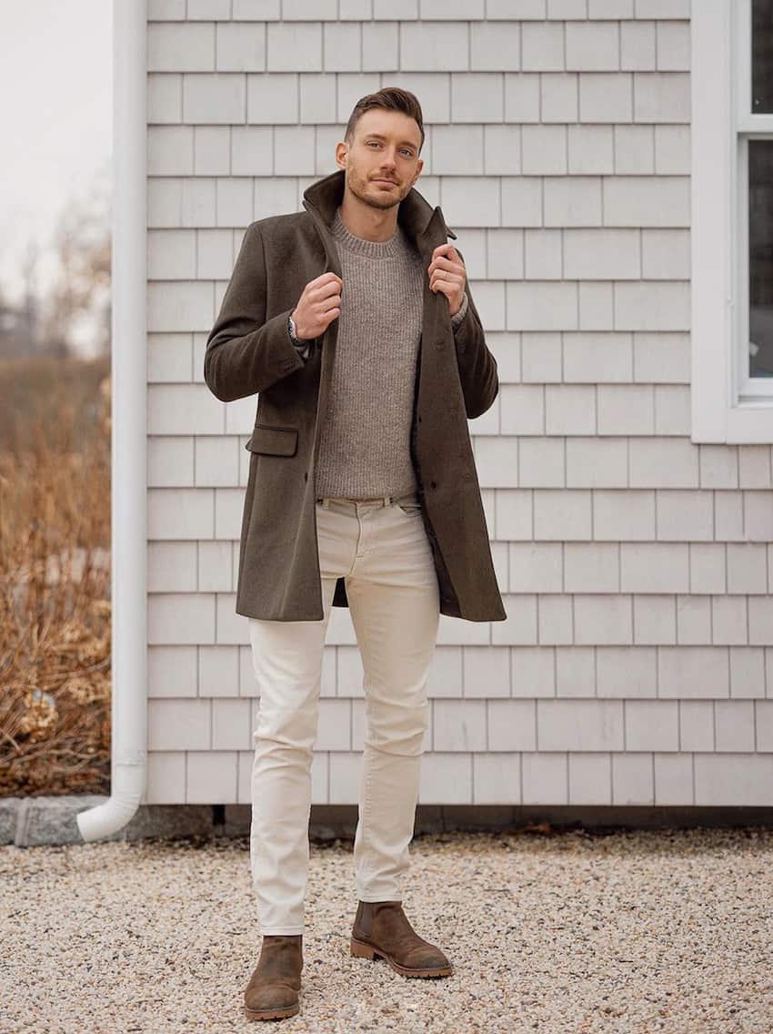 image of a man in light tan chinos, brown Chelsea boots, a sweater, and brown jacket