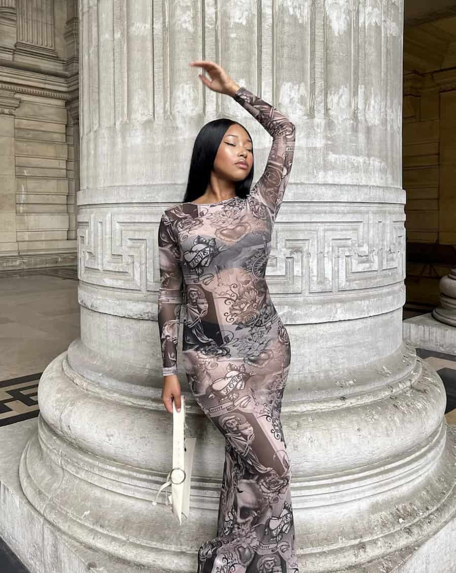 image of a black woman in a printed sheer maxi dress