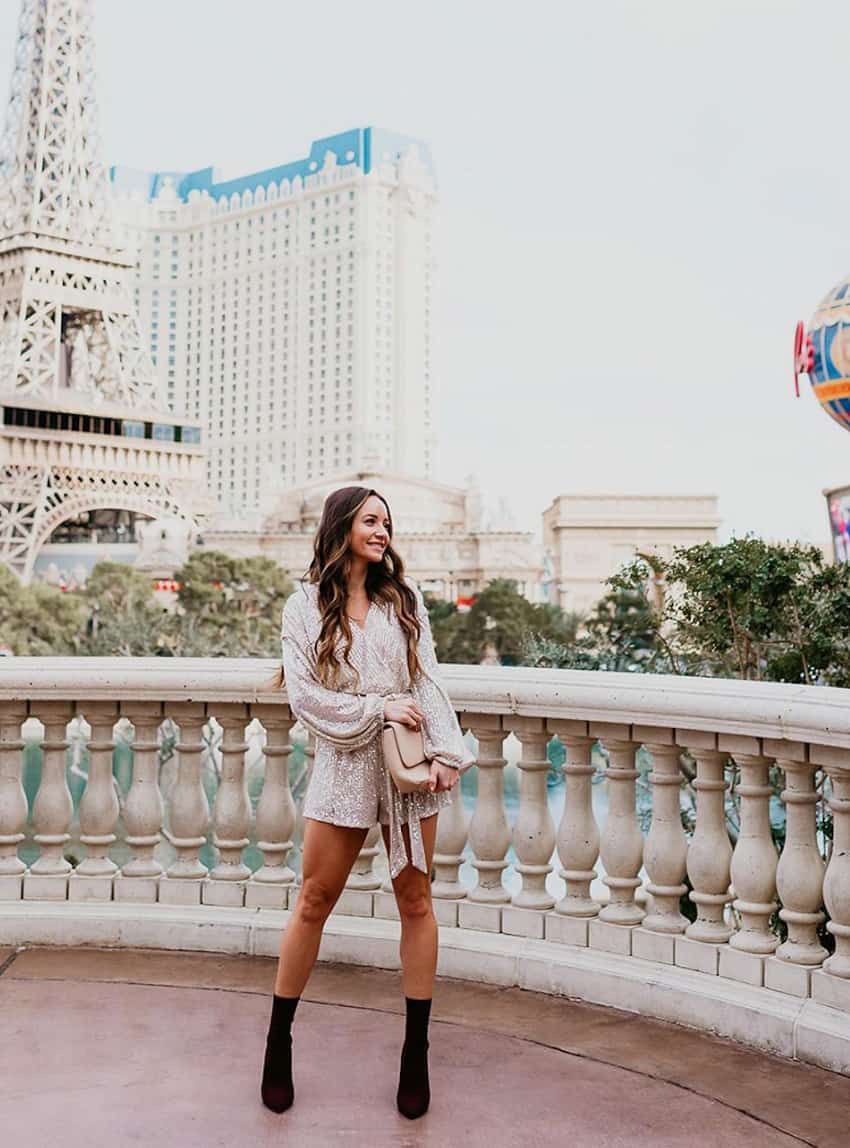 image of a woman in Vegas wearing a sparkly romper and black boots