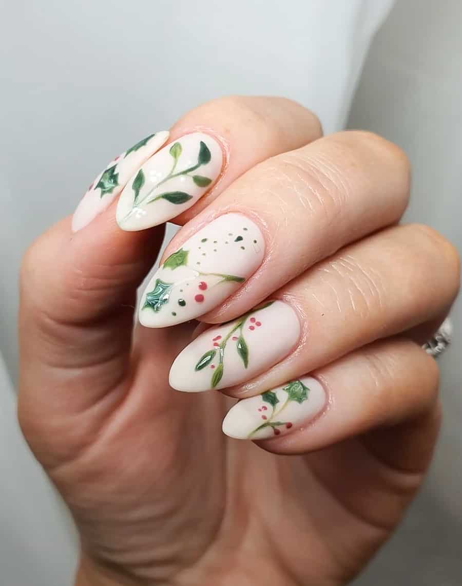 image of a hand with white Christmas nails with a mistletoe design