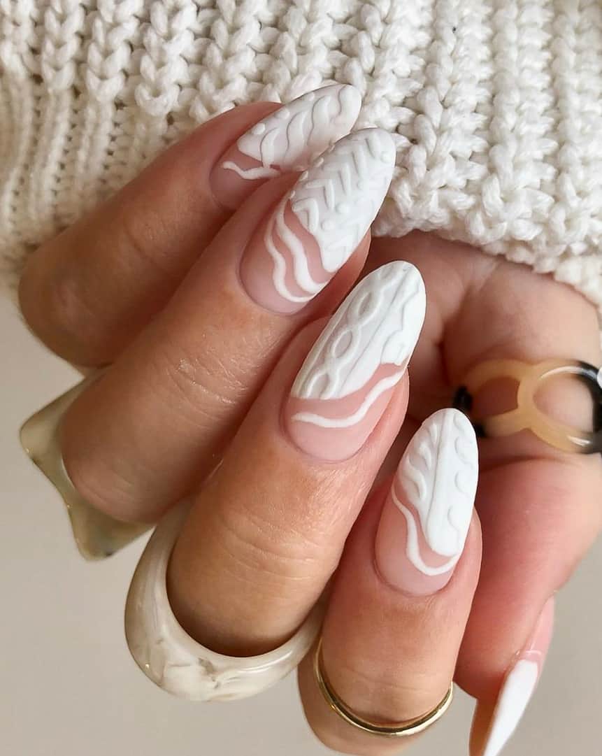 image of a hand with nails that have a white cable sweater design