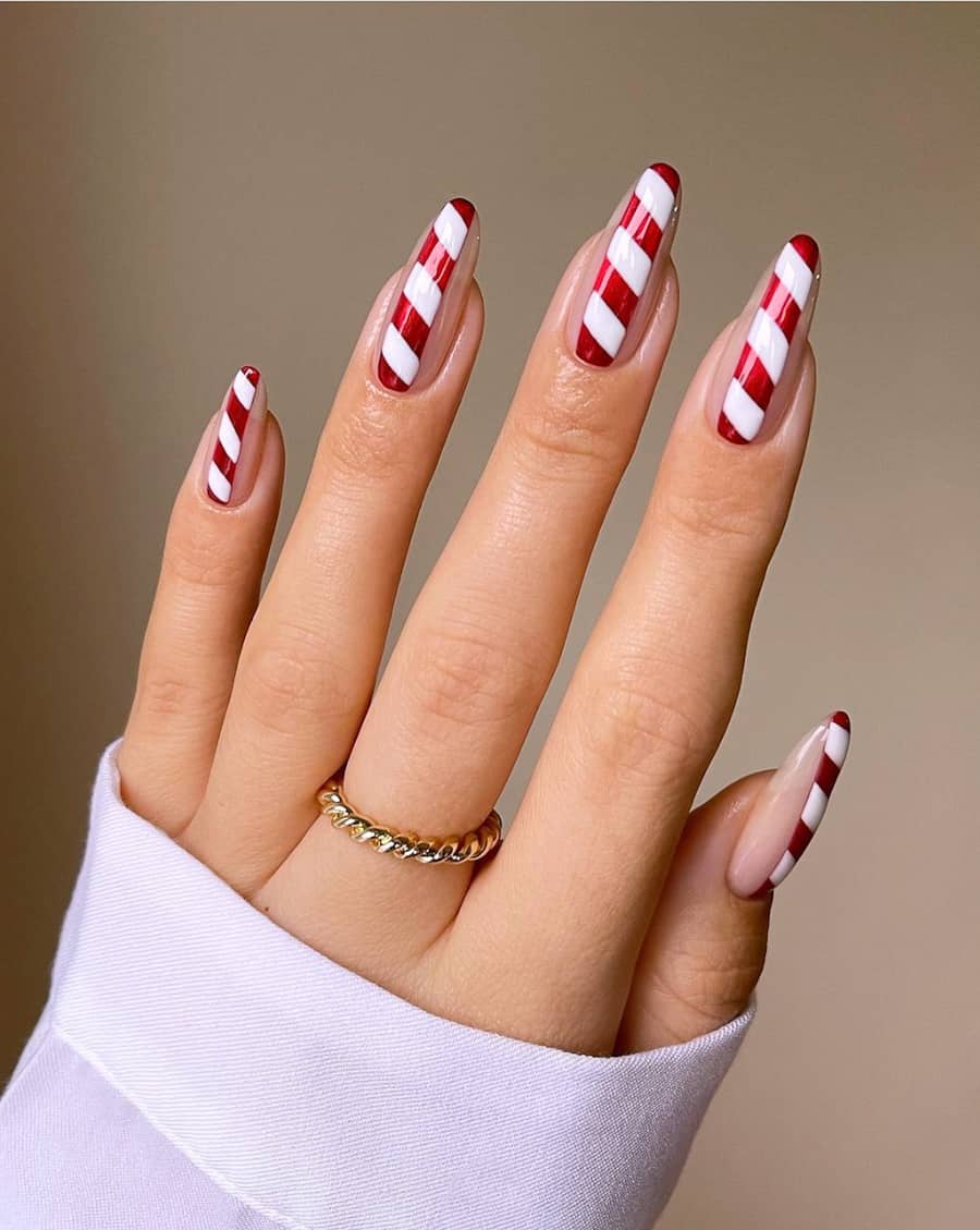 image of a hand with red and white candy cane nails