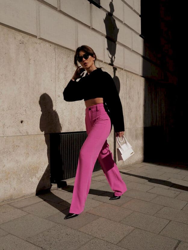 woman wearing pink pants + black cropped sweater