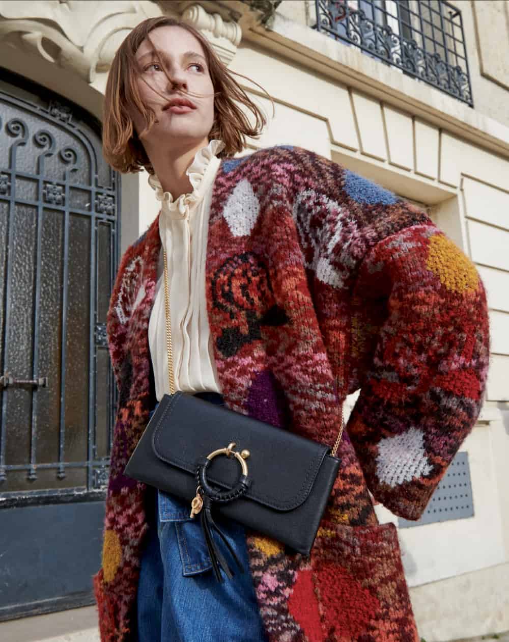 woman wearing a colourful knit cardigan and a See By Chloe bag