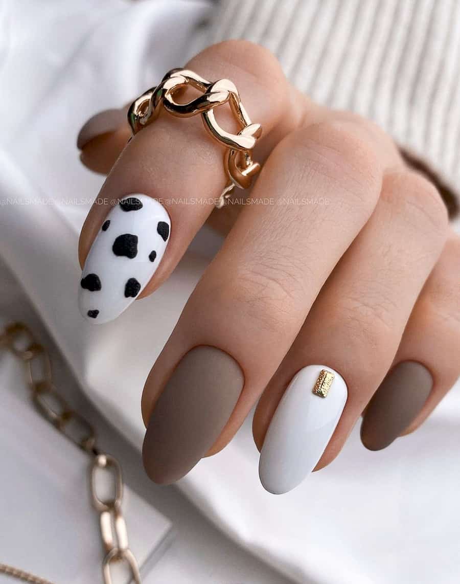 neutral nails with taupe, white, and a cow print accent nail