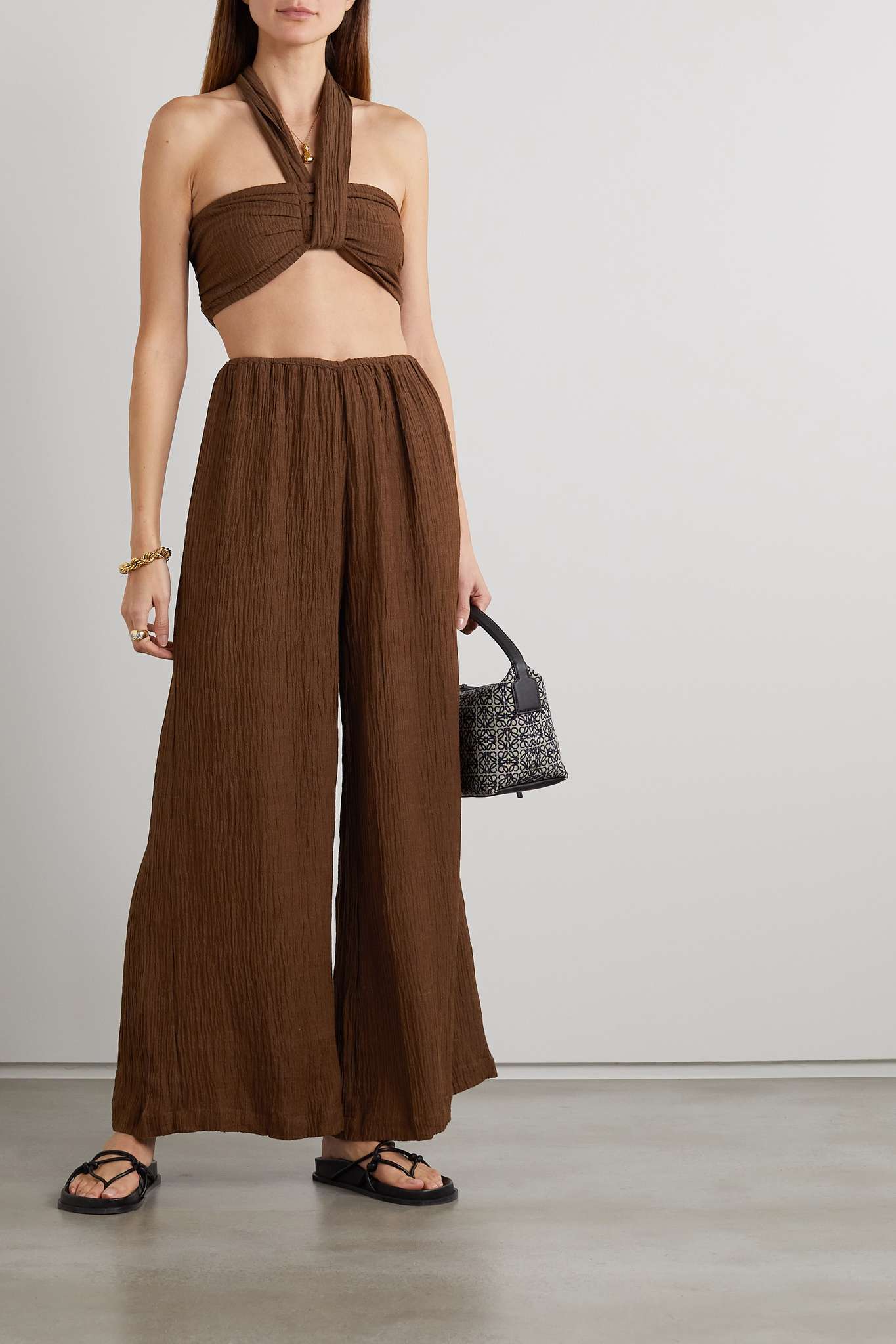 woman weaning a matching cotton gauze brown crop top and pant set with sandals