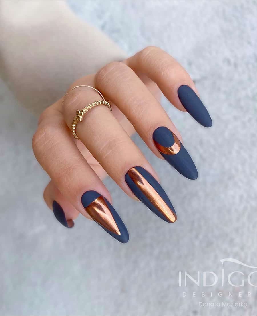 hand with dark navy nails with bronze accents