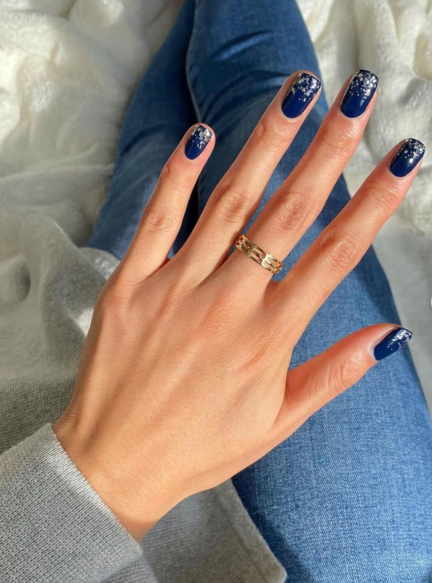 hand with shiny dark blue nails