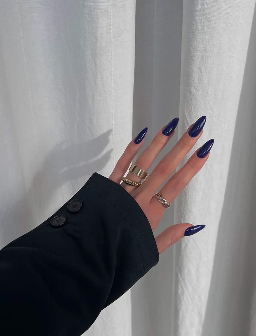 hand with dark blue nail polish