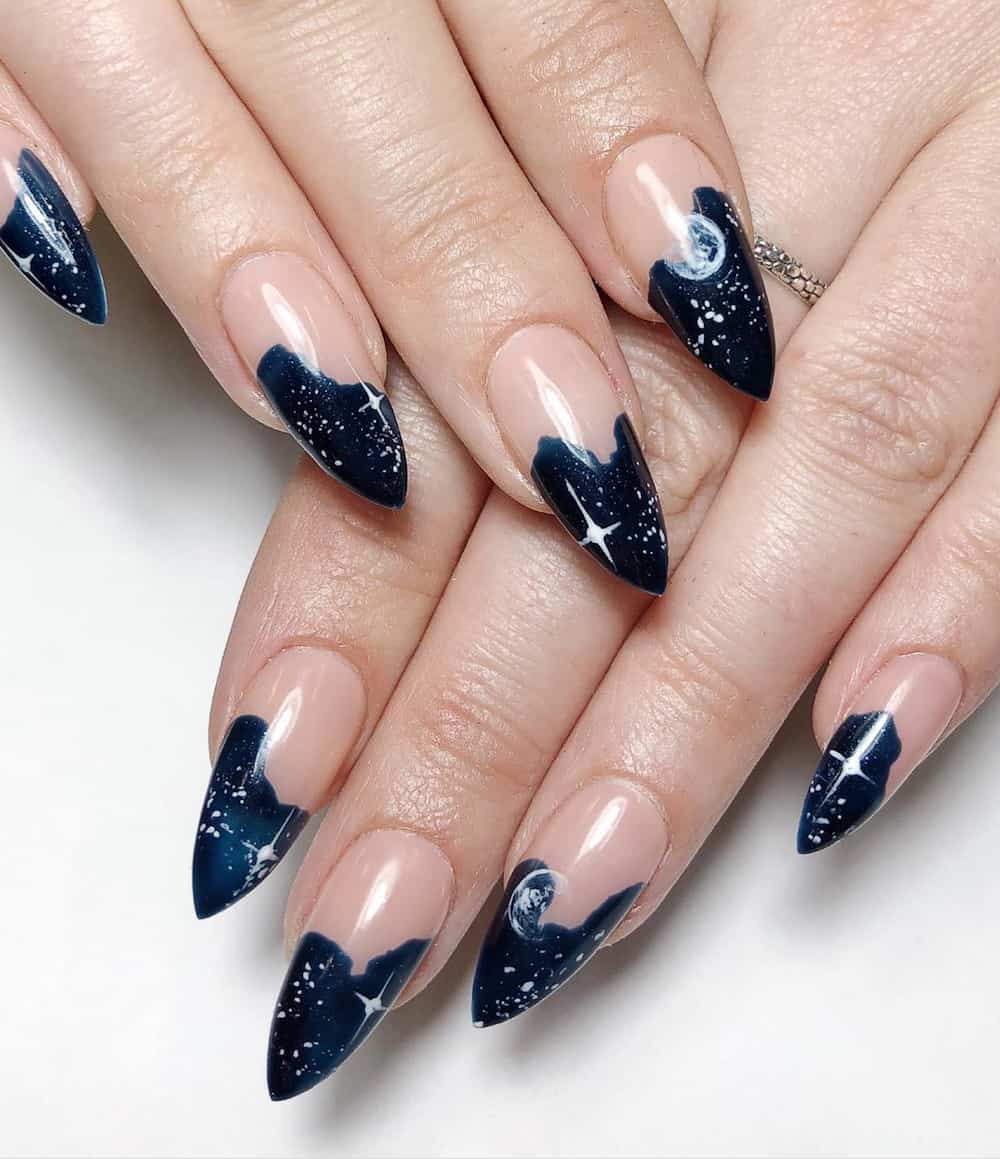 hand with pointy navy blue nails