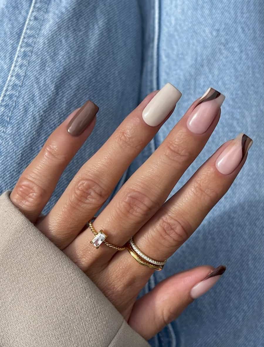 image of a hand with ombre brown, pink, and white neutral nails