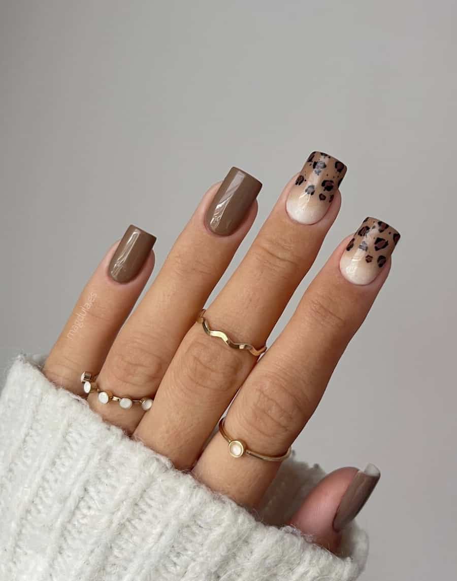 image of a hand with square neutral nails with brown and a brown animal print design