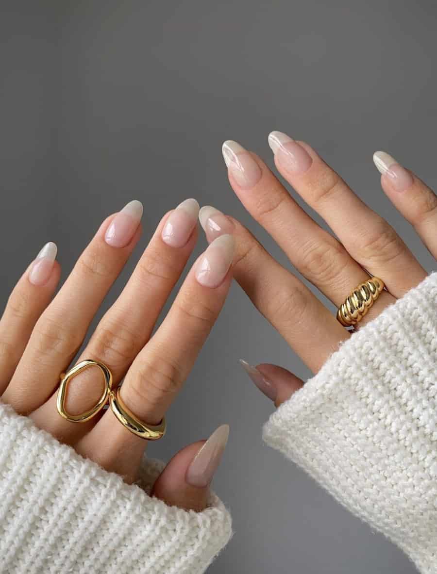 image of two hands with a natural clear gloss manicure