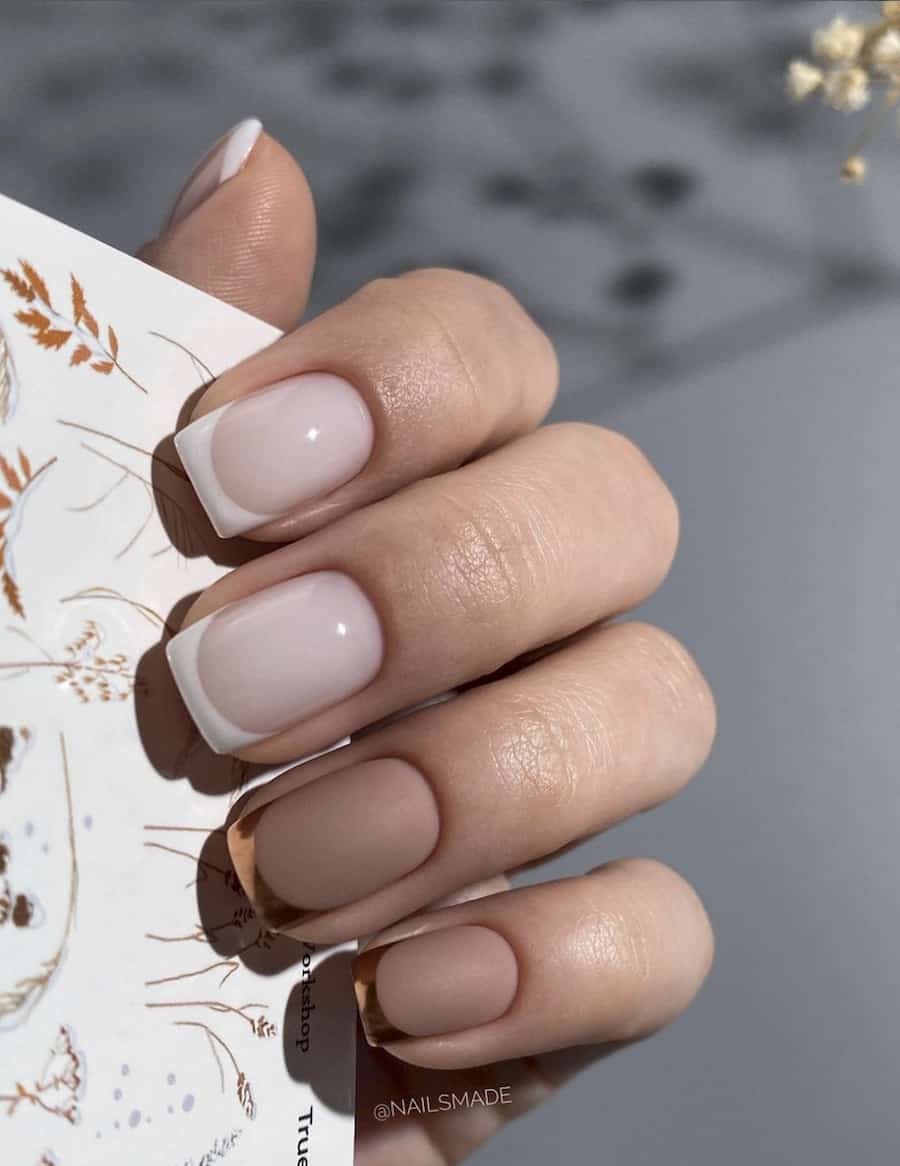 image of a hand with classic French manicure with brown and bronze accents