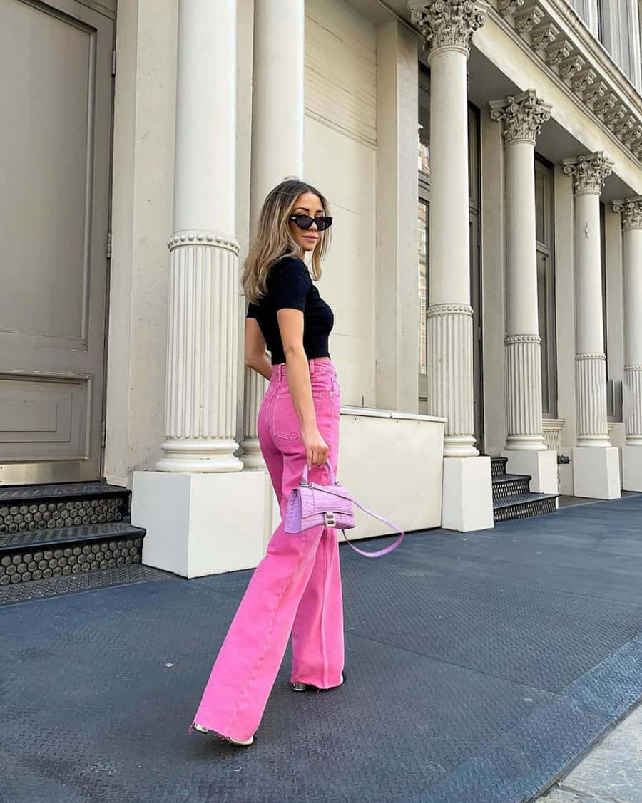 woman wearing hot pink jeans and a black top