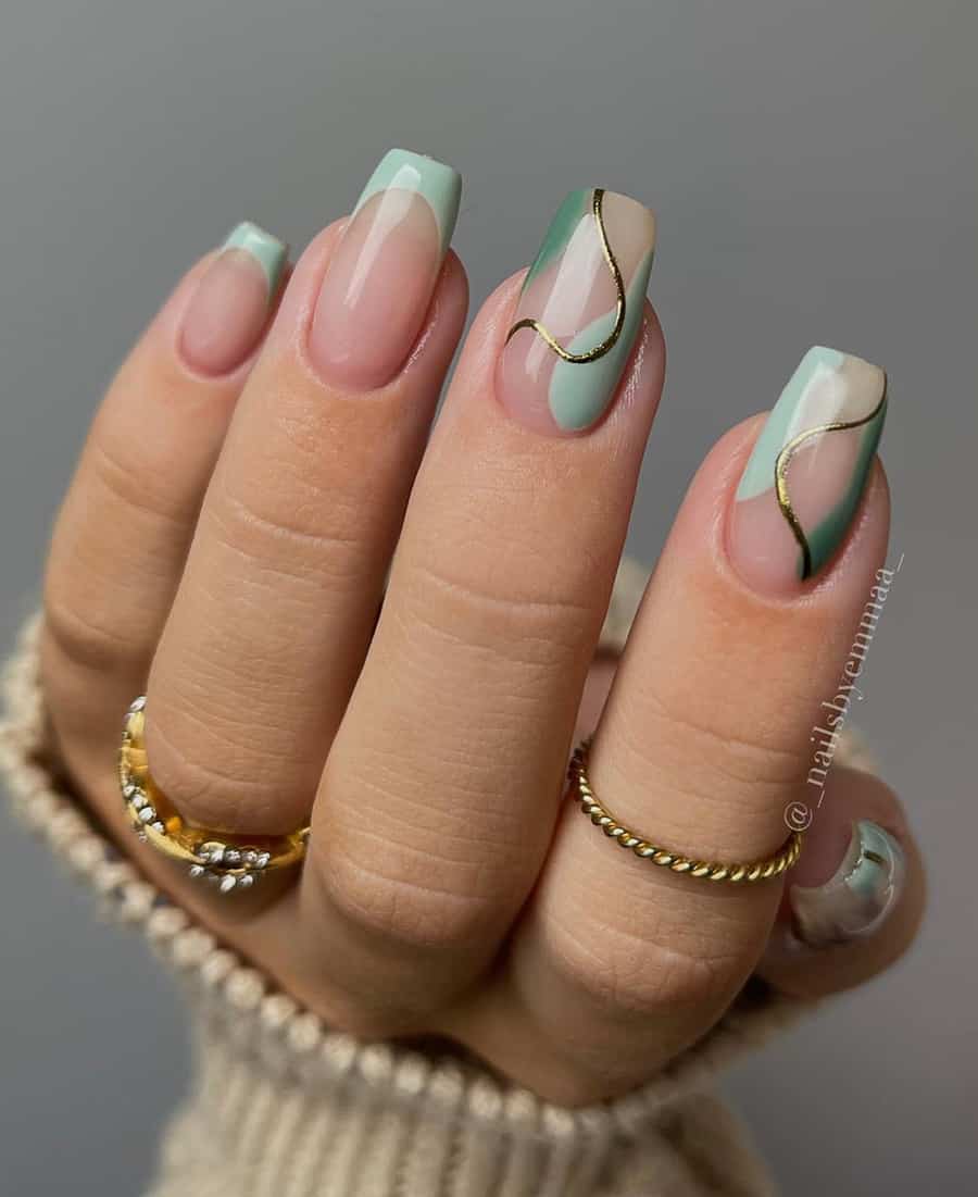 hand with sage green and gold nail art