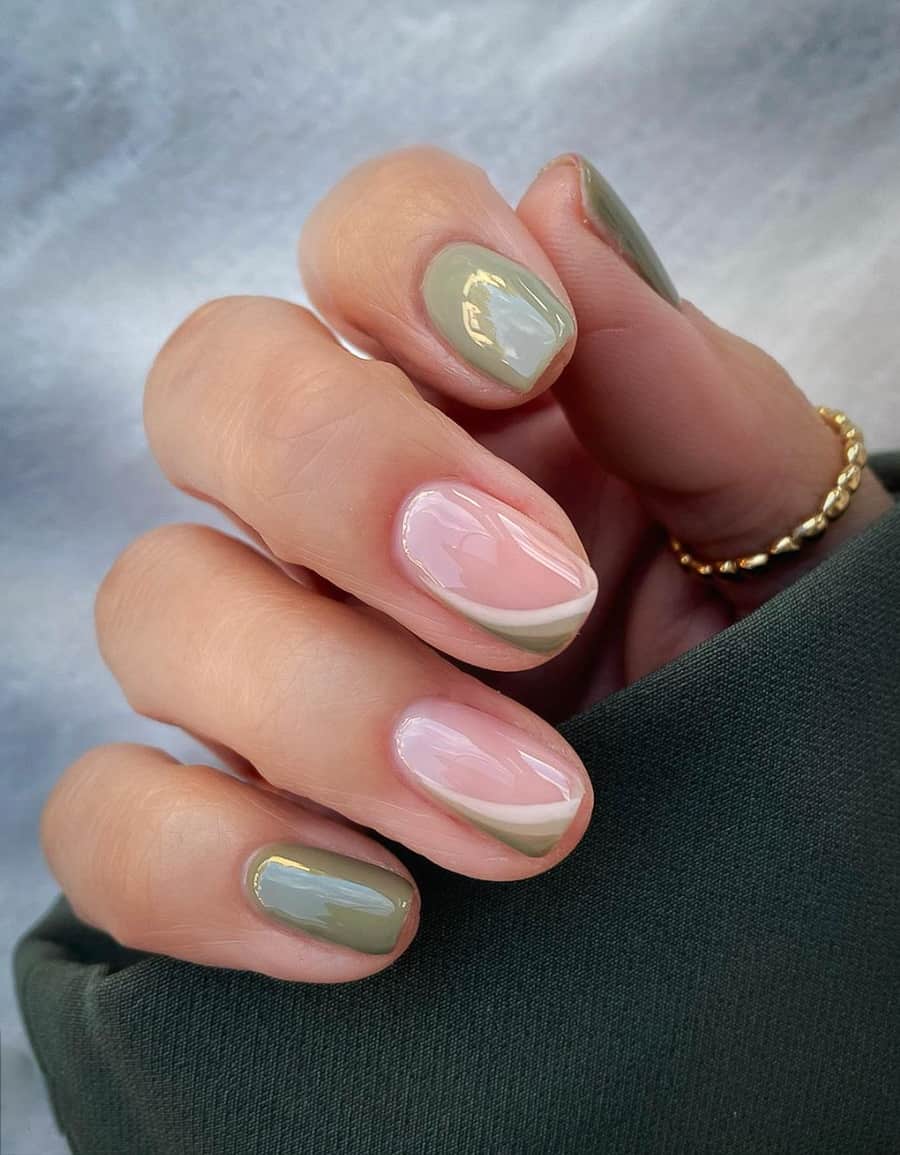 hand with light green and gold nail designs
