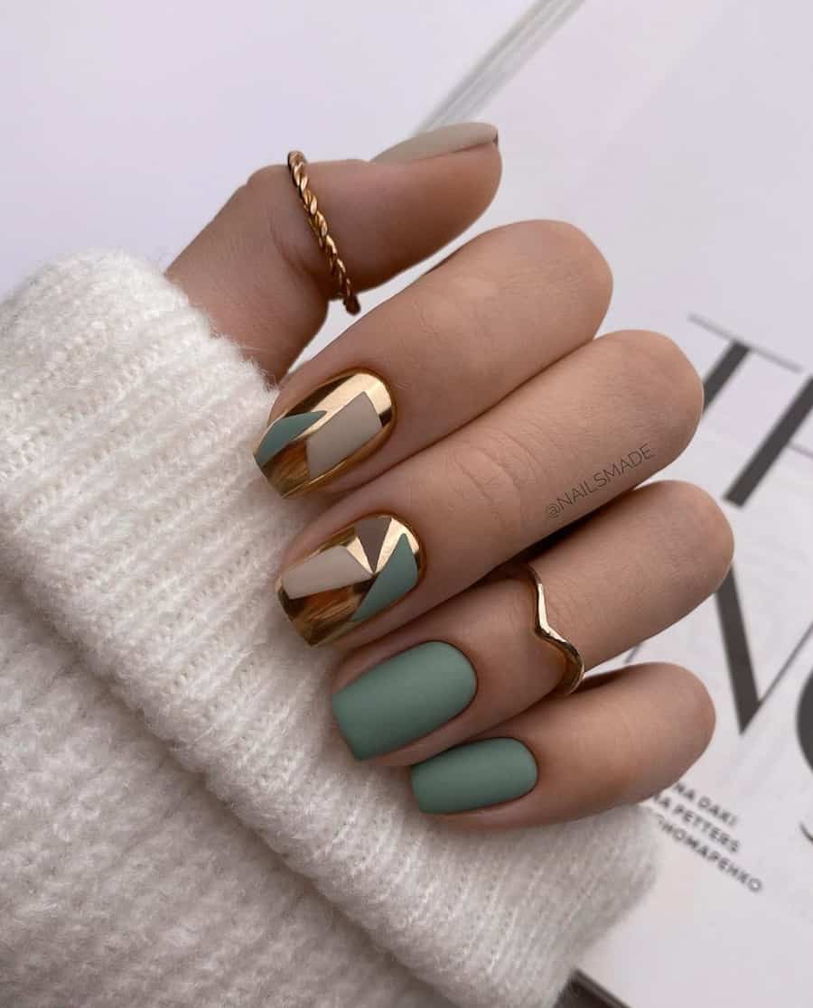 hand with sage green and gold nail art