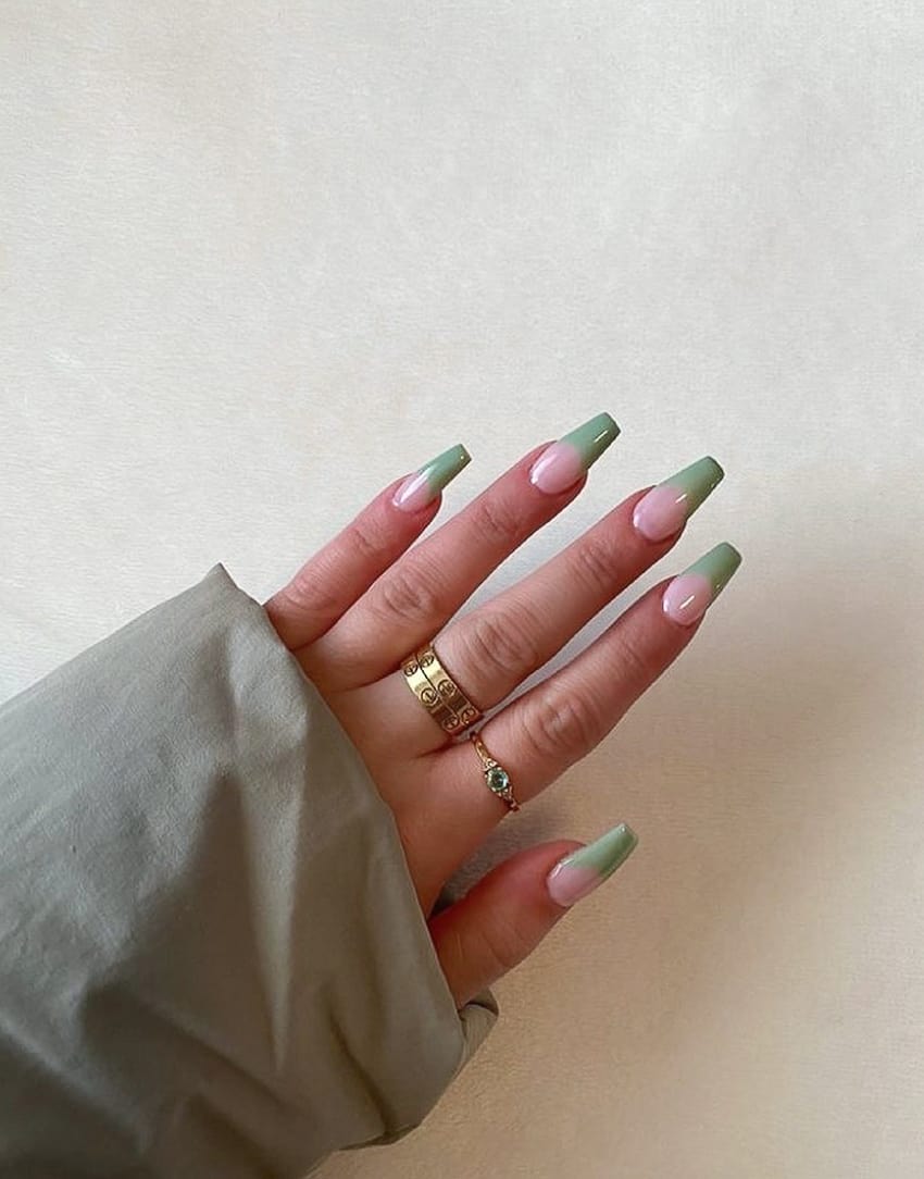 hand with long coffin shape sage green French tip nails