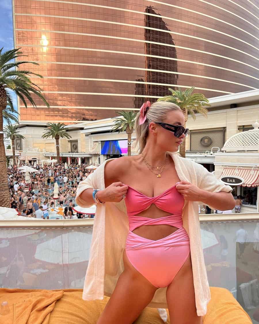 image of a woman at a Vegas pool party wearing an ombre pink one-piece swimsuit