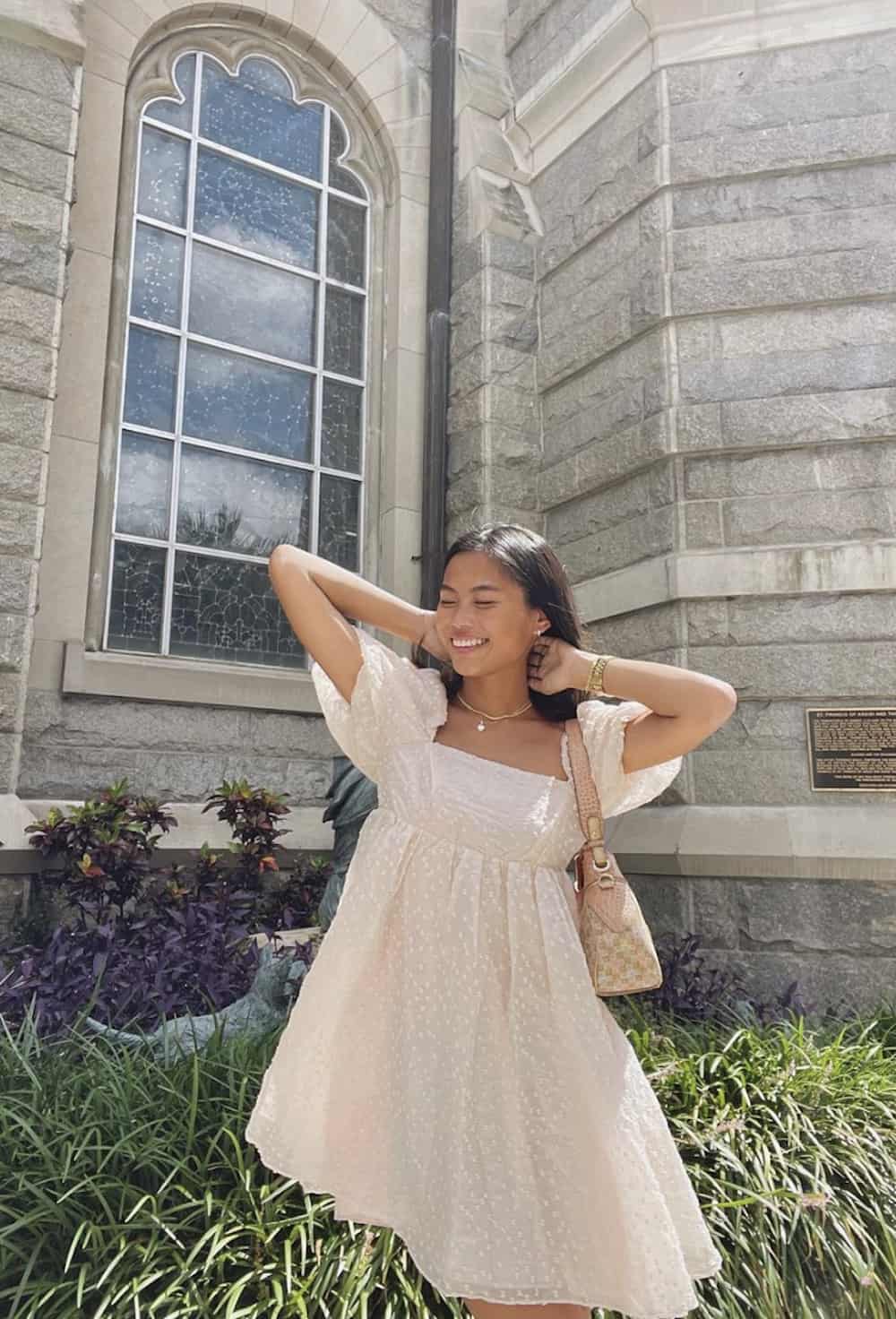 image of a young woman in a floral mini dress with puff sleeves