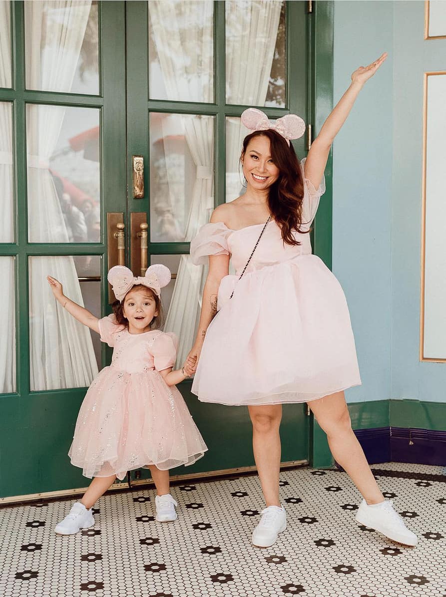 woman in a pink organza dress with her small daughter in a matching dress