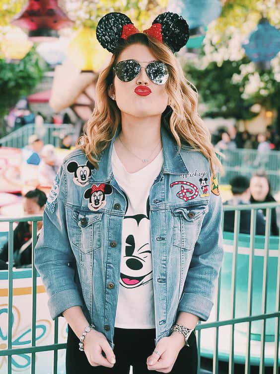 woman wearing a Disney embroidered jean jacket with Minnie Mouse ears