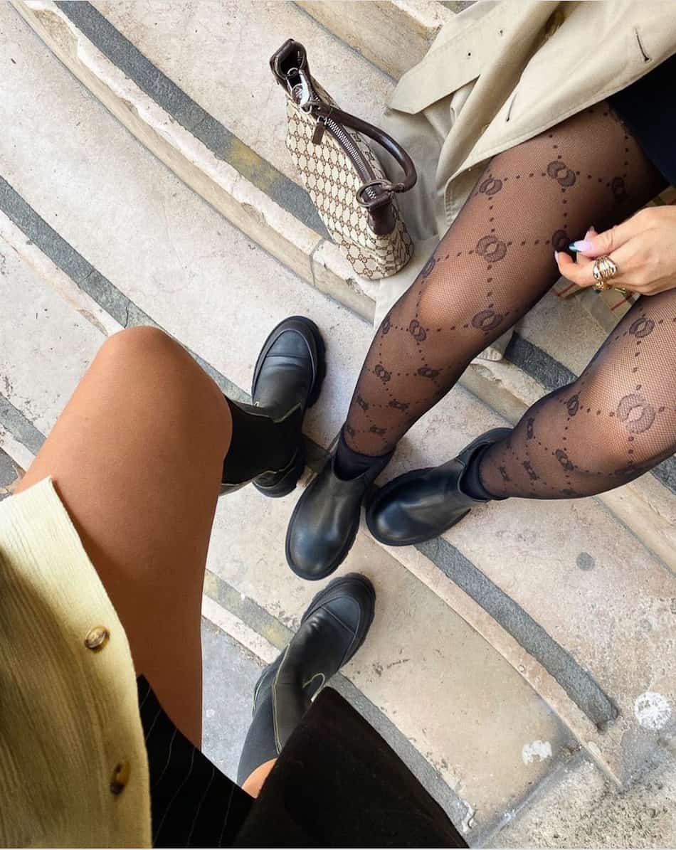 image of two womens legs wearing printed stockings and boots