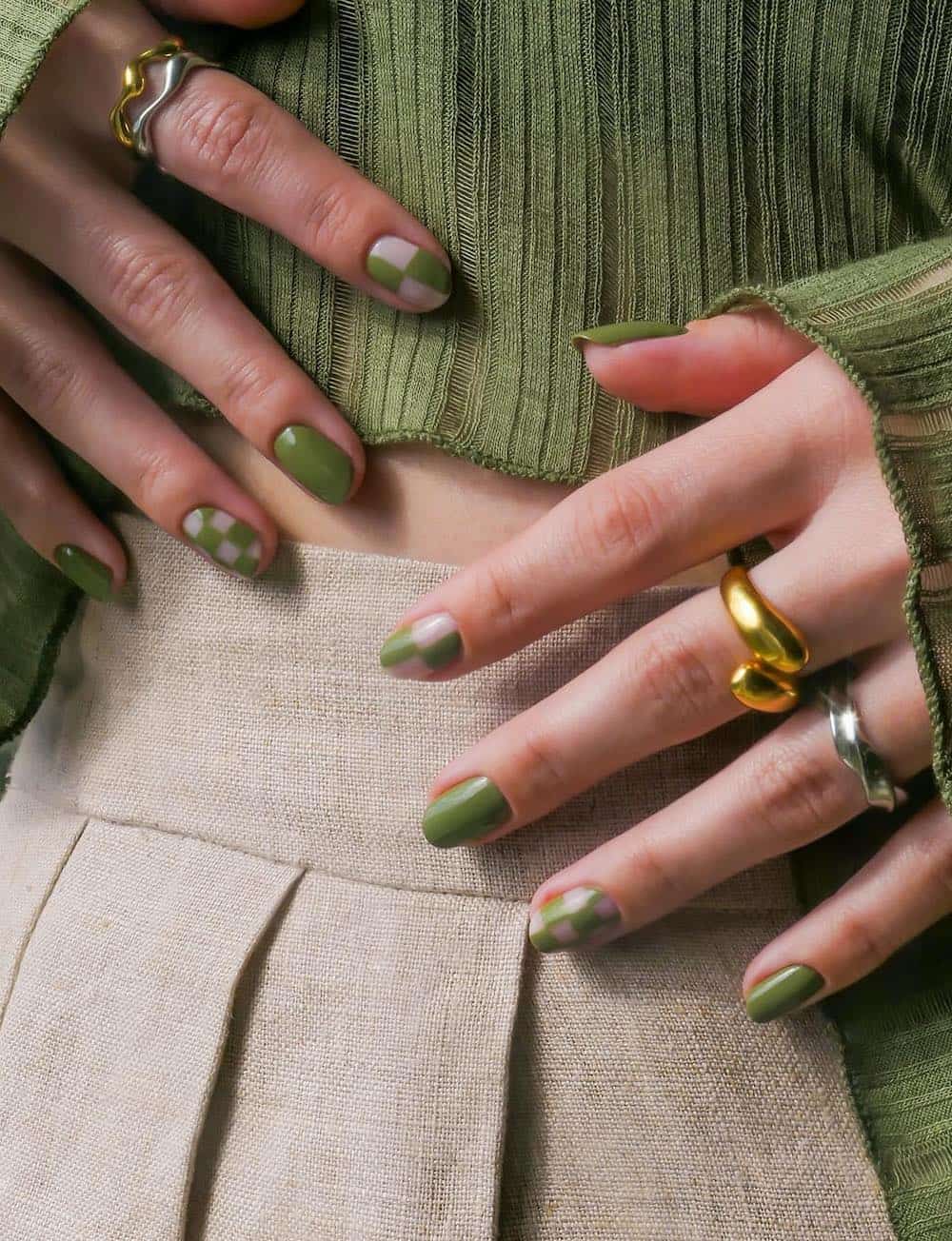 image of two hands with olive green nail designs