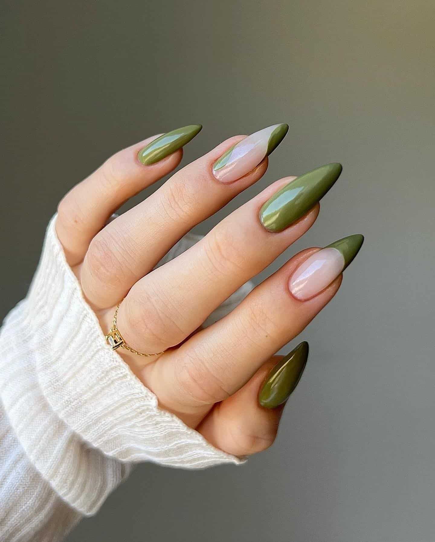 image of a hand with long nails and olive green polish with wave details