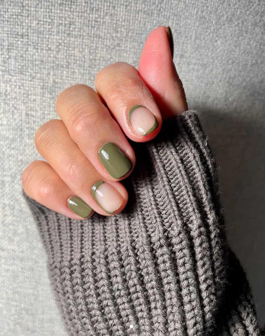 hand with short nails with olive green nail polish and neutral accents
