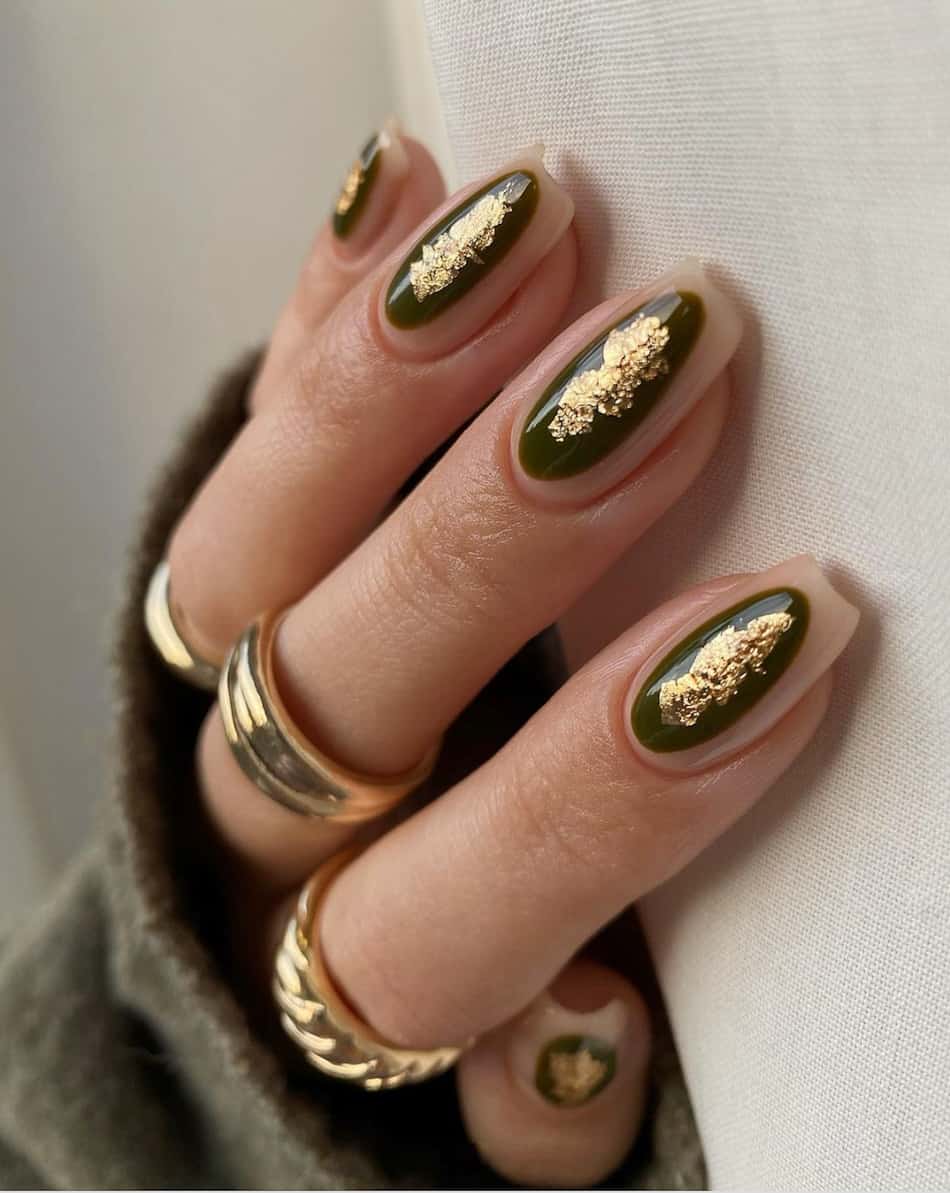 hand with shot coffin nails with olive green ovals and gold foil accents