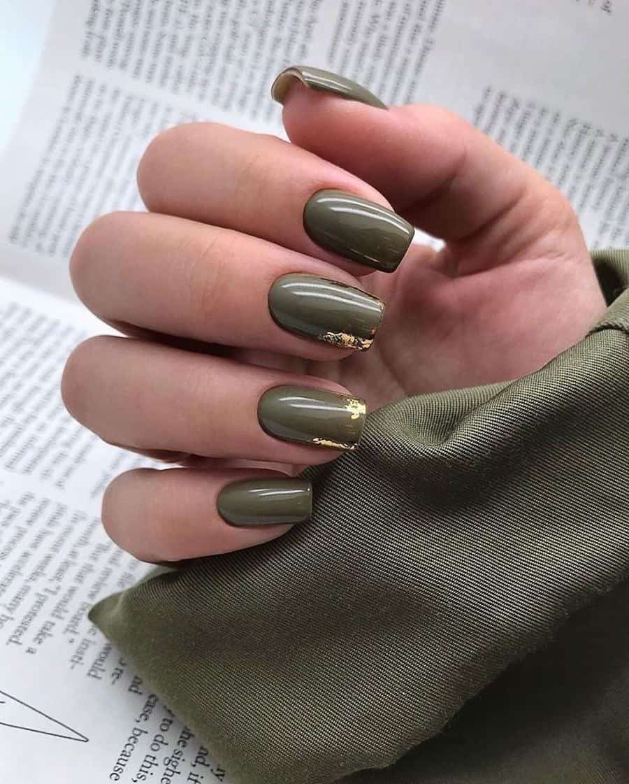 hand with short coffin nails in olive green and gold foil accents