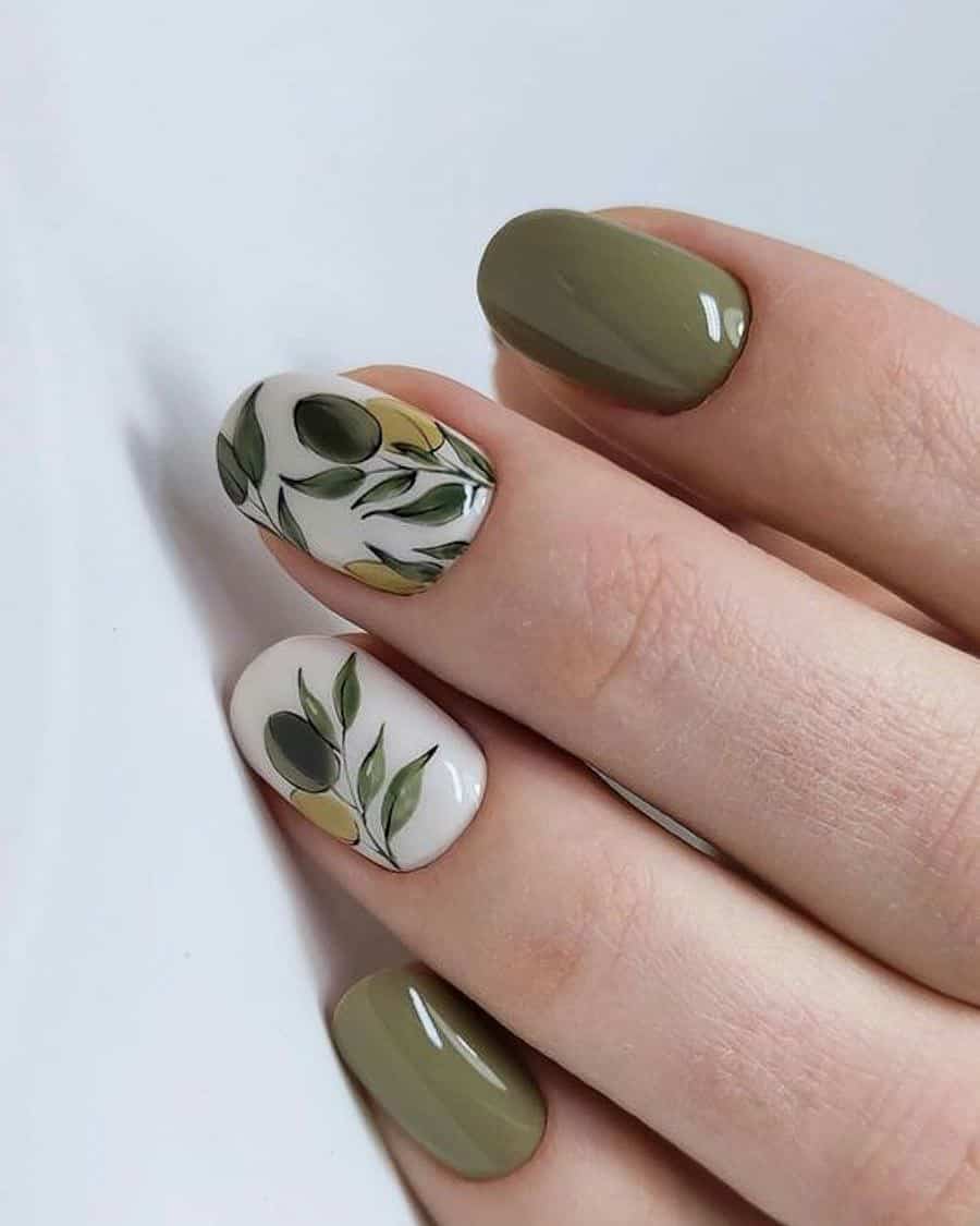 hand with short round nails with olive green polish and painted olive tree branch designs