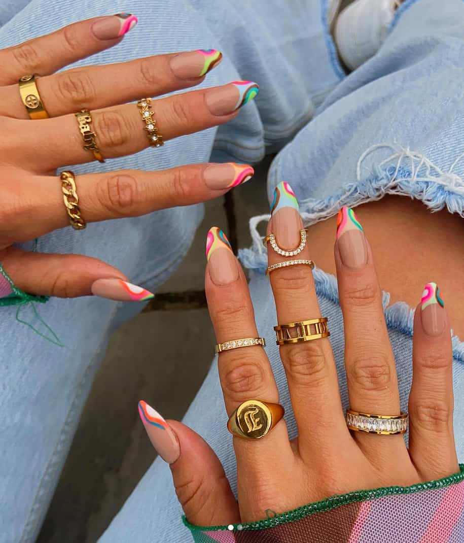 image of two hands with green and pink wavy retro nails