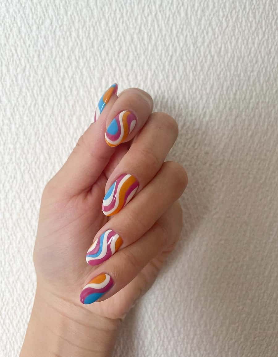 image of a hand with brown, blue, and ivory wavy 70s inspired nails