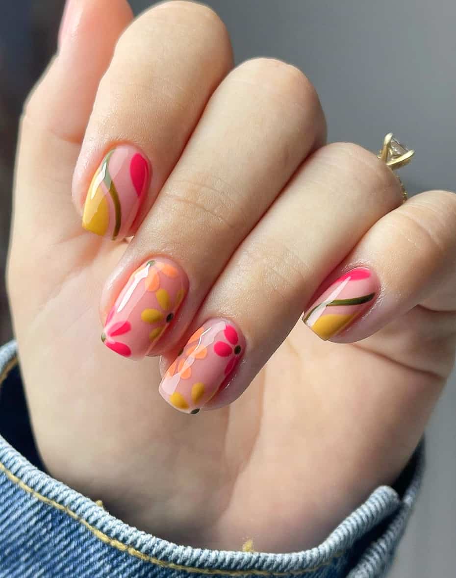 image of a hand with short square nails with pink and orange flower and wavy retro designs