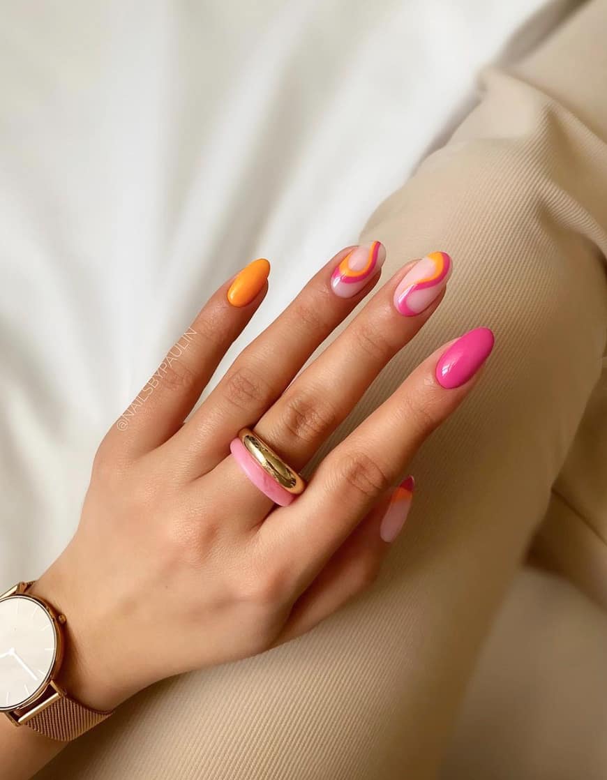 image of a hand with pink and orange nails with waves in a retro design
