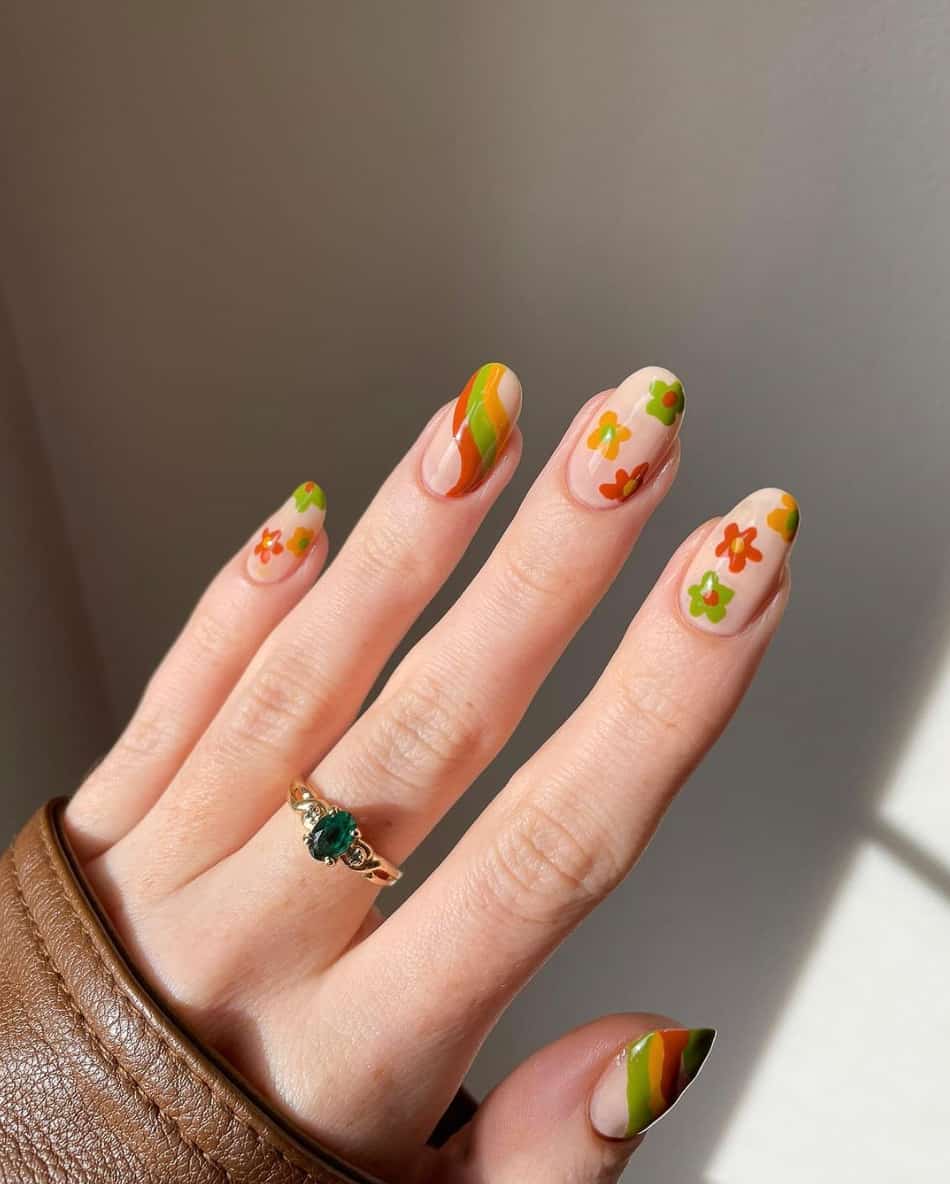 image of a hand with green, brown, and yellow 70s inspired nail art