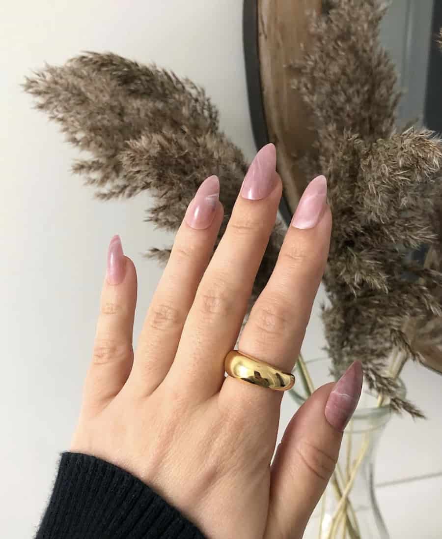 hand with marbled mauve almond nails