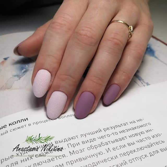 Short, rounded matte mauve manicure. Three nails are a pink mauve with a texture. Two nails are a purple mauve.