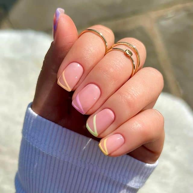 image of a hand with nude short pink nails with pastel line accents