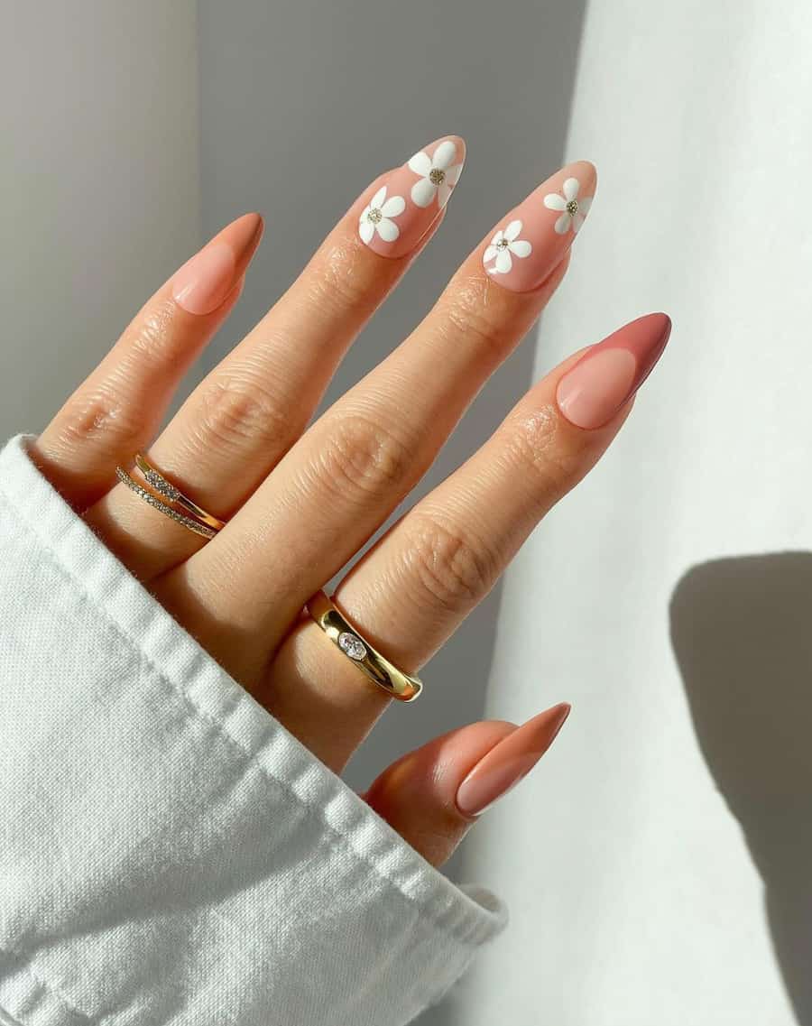 image of a hand with natural nude pink nails with white flower art accents
