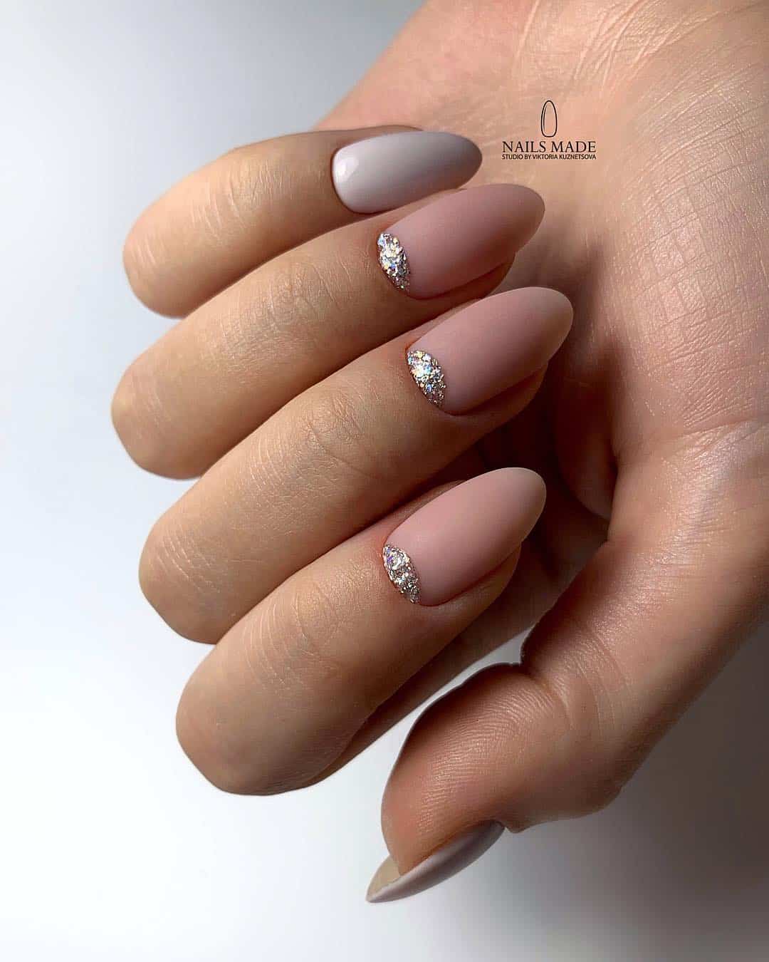 image of a hand with dark nude pink nails with silver accents